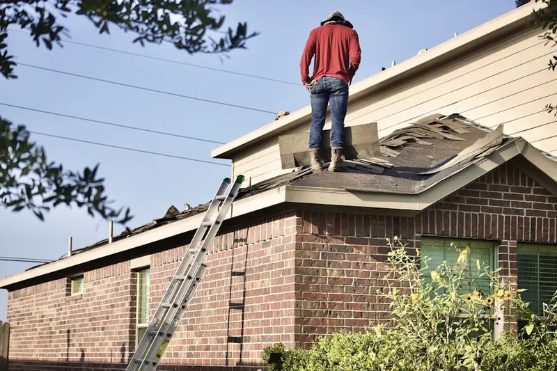 Professional roofer working on a residential roof in DeKalb Farms